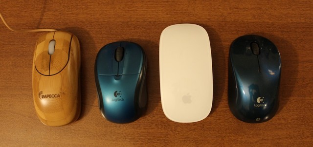 Impecca's wooden mouse, left, is about as long as a standard mouse, but is narrower than my Logitech travel mice and the Apple Magic Mouse.
