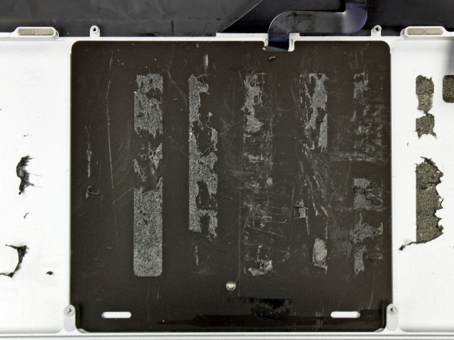 To the left and right of the underside of the trackpad, you can just discern the edges of the sculpted wells that hold four of the Retina MacBook Pro's six Li-Po cells.
