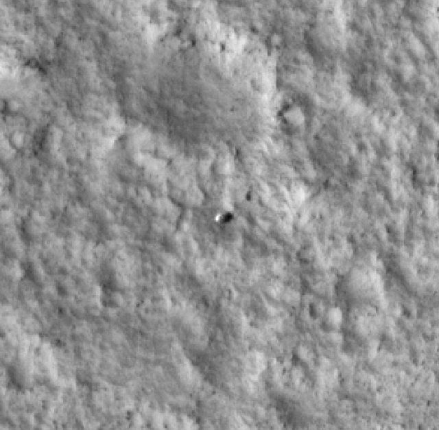 The Viking 1 lander (the small rounded object at center), as seen from orbit by the HiRise camera on the Mars Reconnaissance Orbiter (MRO).