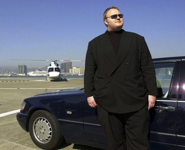 Kim "Billy Big Steps" Dotcom poses beside a car in Hong Kong. 