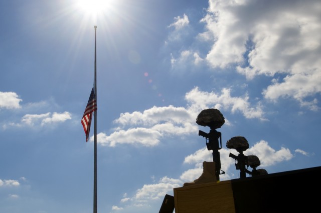 The flag flying at half-staff at a memorial service for the 13 killed at Fort Hood in November, 2009