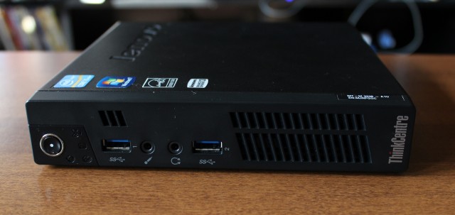 On the front of the M92p: a power button, activity lights, two USB 3.0 ports, and audio jacks.