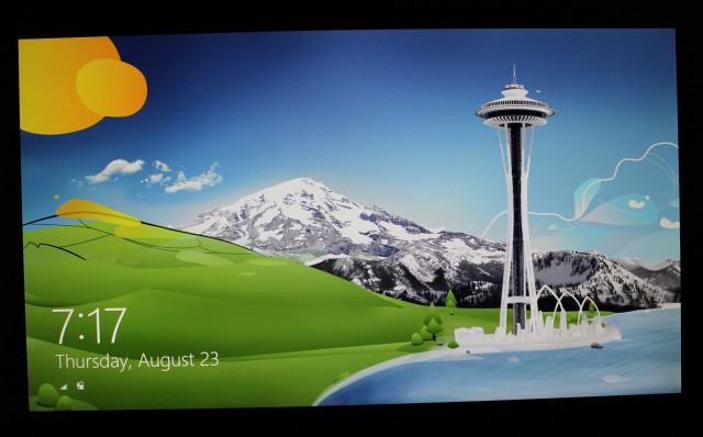 The UX31A's screen viewed straight-on, using one of the colorful login screen wallpapers from Windows 8.