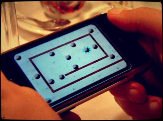 The iPhone makes it easy to get in a quick game while waiting for dinner to be served.