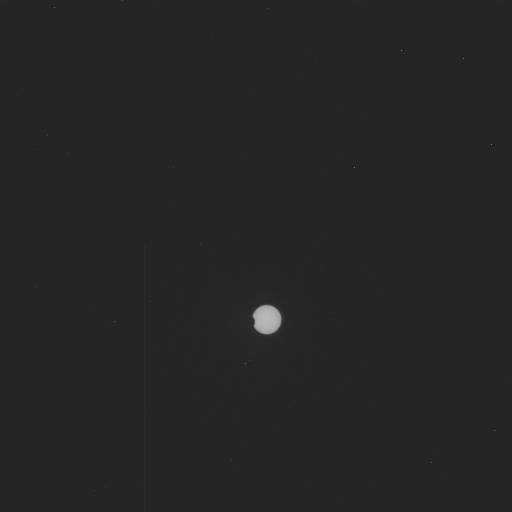 A tiny sliver of the Sun is blocked by one of Mars' moons.