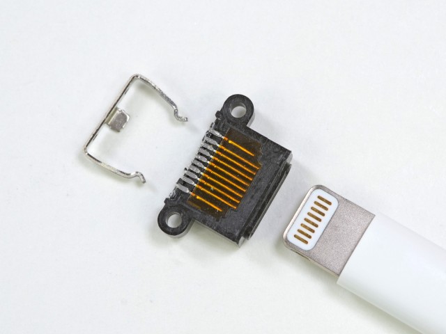 The iPhone 5's Lightning connector disassembled. Note two extra pins, possibly for ground return.