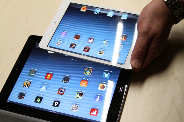 An iPad mini being compared against a fourth-generation (full-sized) iPad.