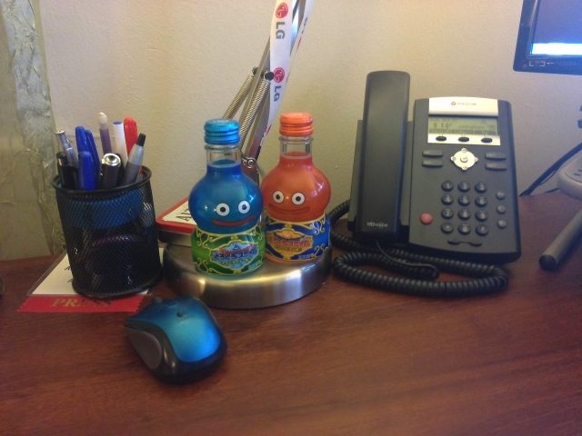 Two pictures of the same desk junk taken in indoor lighting, taken by the iPhone 4S (top) and the VivoTab RT (bottom). The colors in the VivoTab RT's picture are a bit more muted and its image is much softer. The iPhone 4S captures more detail but is visibly noisier.