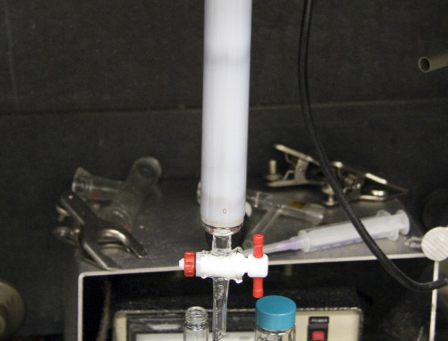 Two populations of carbon nanotubes are separated on a column. The dark band on top is a population of metallic nanotubes; the reddish one at the bottom are the semiconductors.