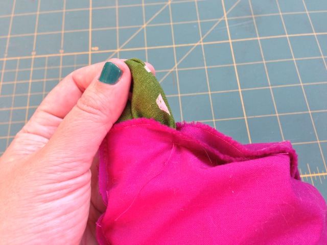 Pull the outer fabric through the hole you left in the lining until the whole thing gets turned right-side-out.