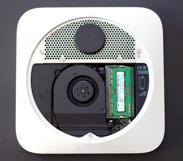 The mini, with the bottom cover removed. Visible is the Airport Wi-Fi antenna at top, the RAM at right, and the system's single fan.