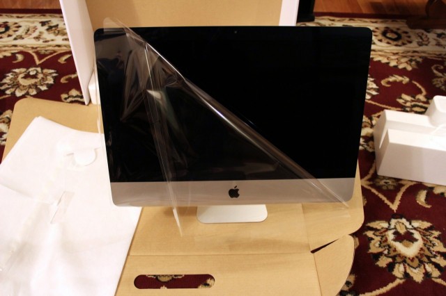 Peeling the cloth and plastic wrappers off of the iMac will reveal your new computer.