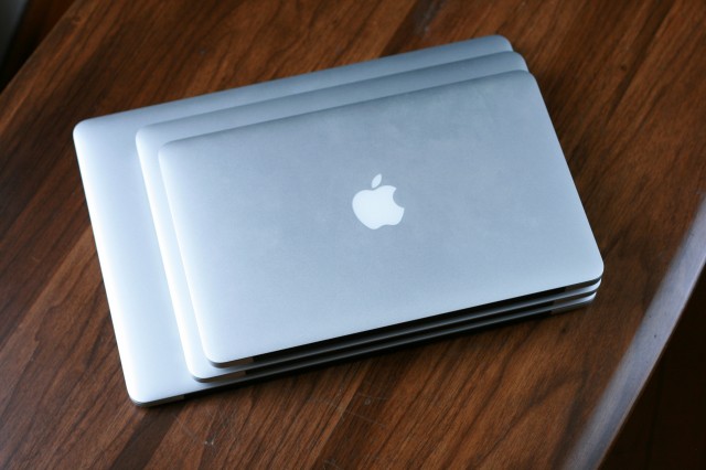 A stack of MacBooks, with a 15" Retina MacBook Pro on the bottom, a 13" Retina MacBook Pro in the middle, and an 11" MacBook Air on top.