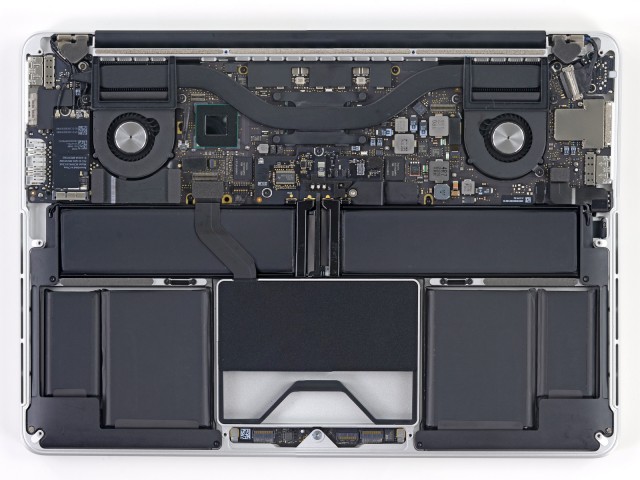 The inside of the 13" Retina MacBook Pro. Note the two fans connected to the processor by heat pipes, and the SSD module tucked in underneath the trackpad.