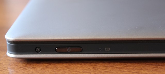The power button and LEDs are on the front edge of the laptop.