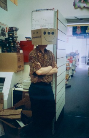 The author, guarding the back room with box on head. In my shirt's defense, it was the 1990s. Everyone dressed like this.