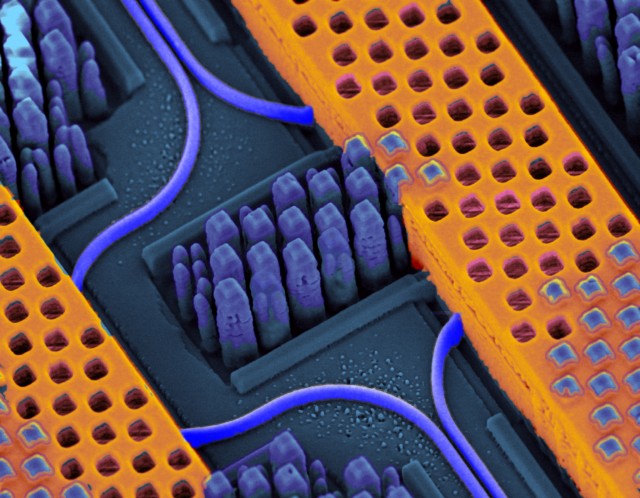 IBM's integrated silicon nanophotonics transceiver on a chip; optical waveguides are highlighted here in blue, and the copper conductors of the electronic components in yellow.