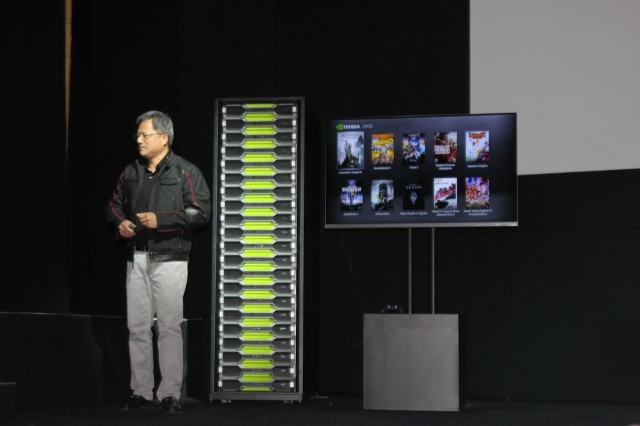 Jen-Hsun Huang next to a rack of Grid servers.