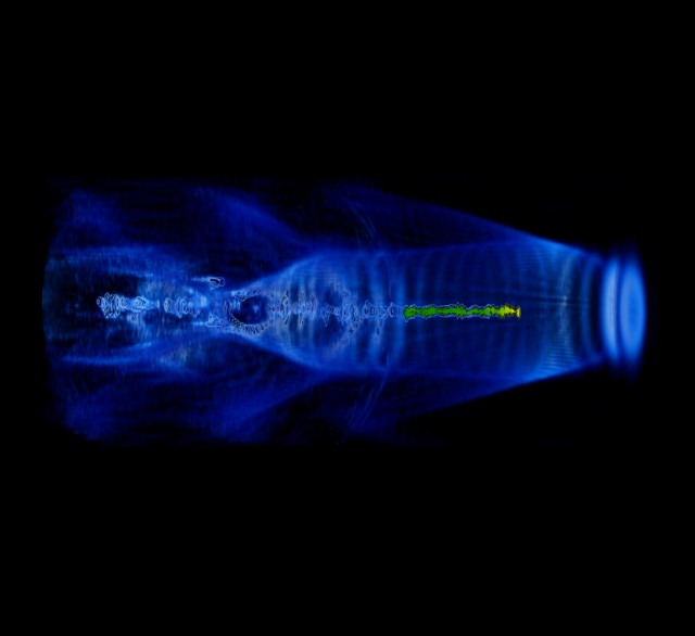 Computer simulation of a laser plasma accelerator, showing the waves in the plasma that accelerate charged particles. A new experiment has extended this design to accommodate neutral particles as well.