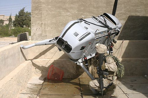 A drone that crashed on the roof of an Iraqi house is recovered by Marines in 2006.