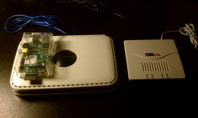 Ruiz's Raspberry Pi, a Netgear switch, and Obi110 telephone adapter.