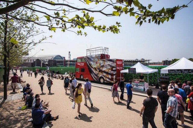 For now the King's Boulevard is lined with a few street vendors, but those faux-ivy green plywood walls hide an active construction site.