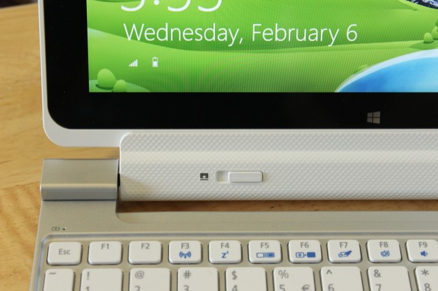 Slide the dock retention slider over a bit to detach the tablet from the keyboard dock.