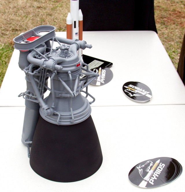 A small model of the proposed F-1B design, on display at the gas generator test firing. Visible in foreground and middle are Pyrios stickers with logo. I grabbed a bunch of these.