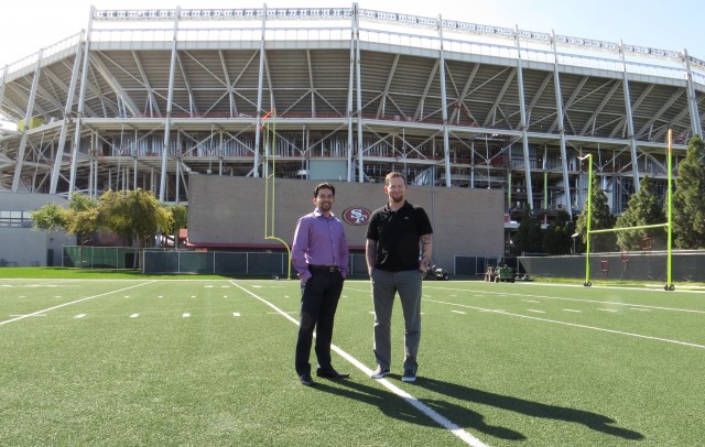 49ers CTO Kunal Malik (left) and Senior IT director Dan Williams (right) stand in front of Santa Clara Stadium.