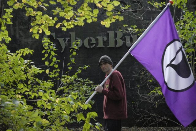 Sven Olaf Kamphuis waving the Pirate Party flag in front of CyberBunker's nuclear bunker.