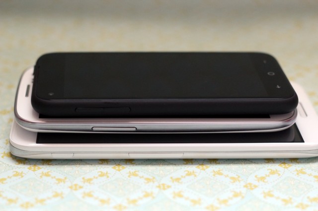 The HTC First stacked on top of the Samsung Galaxy S III, which is stacked on top of the LG Optimus G Pro.