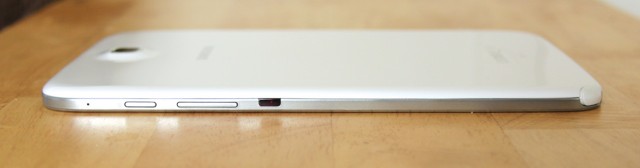 The power button, volume rocker, and IR blaster are on the tablet's right edge.