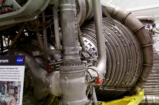 Detail on the upper thrust chamber of an Apollo-era F-1 engine. Note the tightly packed series of tubes, bound together with barrel-like hoops—these recirculate RP-1 fuel to cool the nozzle, similar to how the methane aerospike engine recirculates fuel through its plug. New engine, tried-and-true cooling strategies.