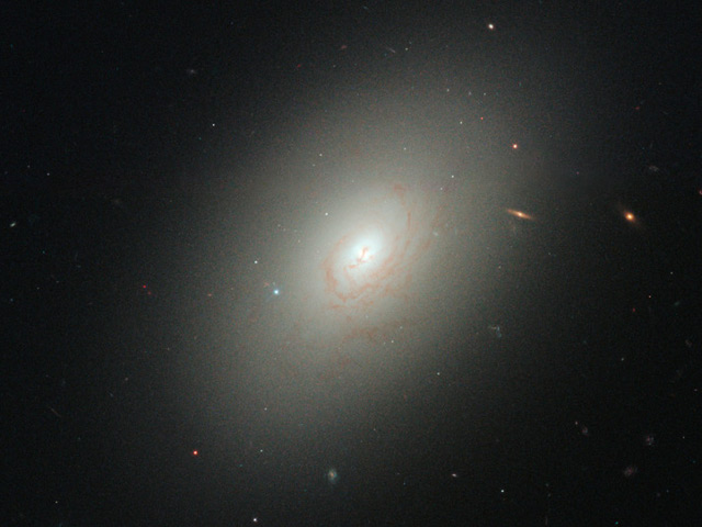 The elliptical galaxy NGC 4150. Observation of a merger between two galaxies early in the life of the Universe could explain the origin of large elliptical galaxies.