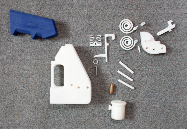 The components of the Liberator pistol, including plastic springs and barrel. Metal nail firing pin visible at center.