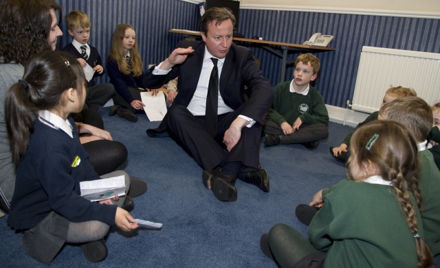 Prime Minister David Cameron speaking with children in March 2013.