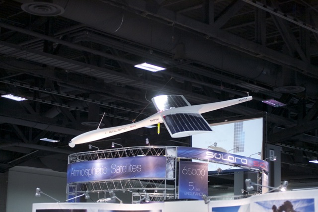 A model of the Solara 50, Titan Aerospace's commercial "atmospheric satellite," hangs above the company's booth at the AUVSI Unmanned Systems conference in 2013.