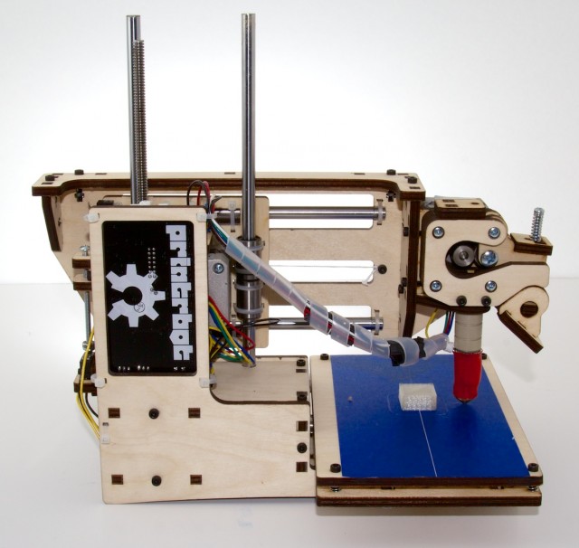 The Printrbot Simple, with the factory-printed test object still attached to the bed.