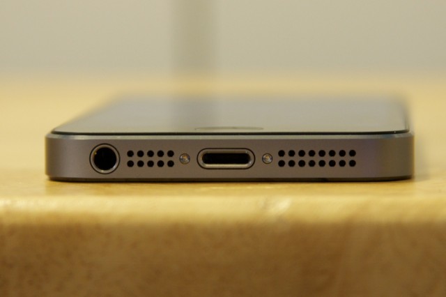 The headphone jack, speaker grilles, and Lightning port on the bottom of the phone.