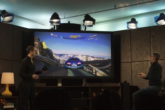 Two execs play a game with the Fire TV. 