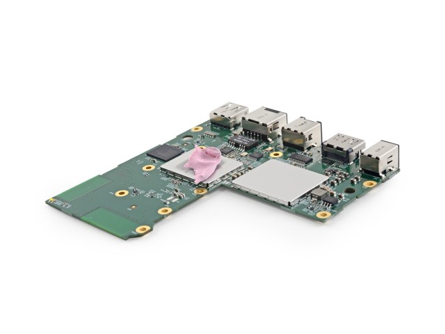 The system board and its bubblegum-pink thermal pad, separated from the Fire TV's large heatsink.