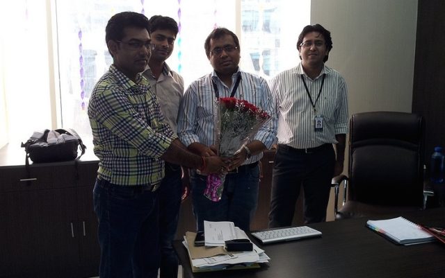 PCCare247 employees presenting flowers to Vikas Agrawal on his birthday.