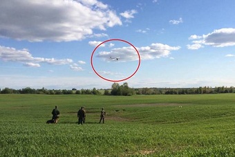 A photo from the Russian FSB, showing the drone flying as it was met by border guard officer.