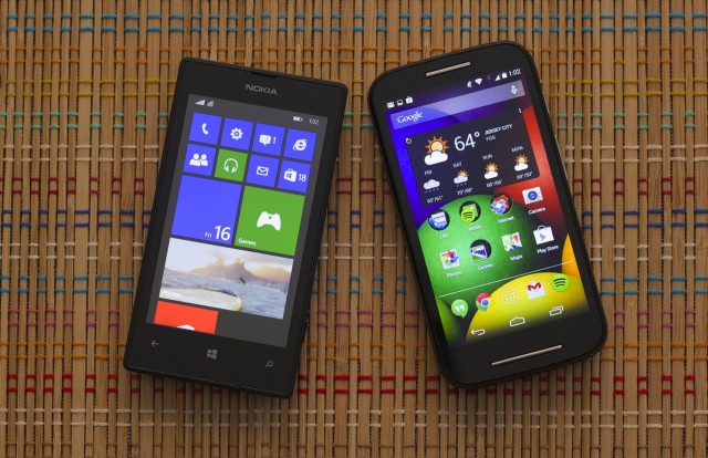 The Moto E (right) next to the Lumia 520, Microsoft's current budget Windows Phone offering.