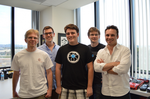 John Carmack (left) poses with Oculus founder Palmer Luckey (center) and other members of the Oculus team.
