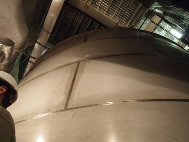 The LUX experiment is inside a metal tank containing 71,600 gallons of pure water, so the xenon detector isn't visible. The head at lower left is LUX researcher Rick Gaitskell.