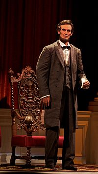 The animatronic president Lincoln standing to deliver his speech.