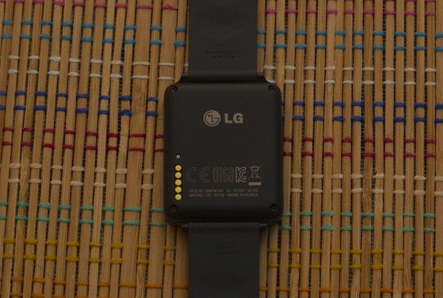 The G Watch just has pogo pins. Its completely flat back is less comfortable against one's wrist.