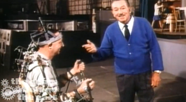 Disney engineer Wathel Rogers in the control harness, on the left, used for programming animatronic characters' movements, with Walt Disney on the right.