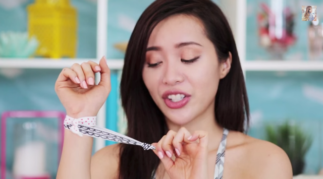 Michelle Phan, a very popular YouTube user, demonstrates the stretchiness of hair ties. 